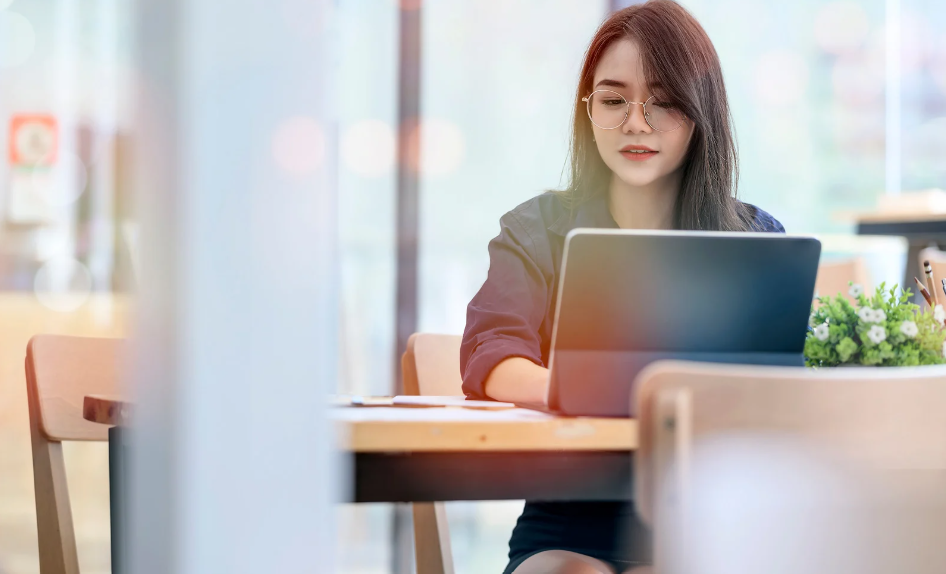 woman using laptop configured by zero touch