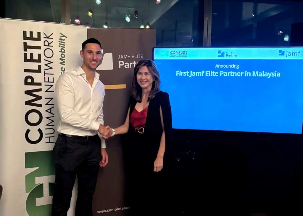 Ceo of complete human network shaking hand with ceo of Jamf