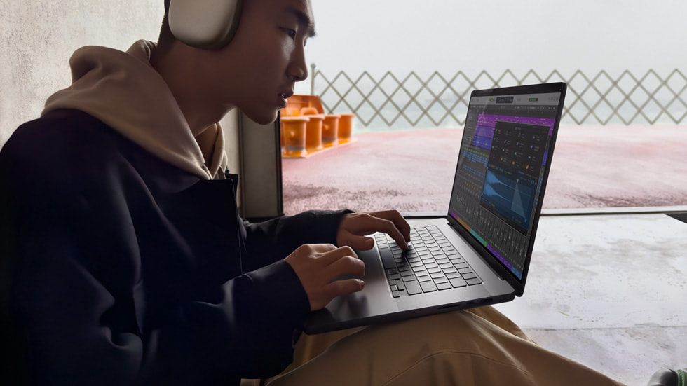 A guy wearing headset editing video using final cutpro