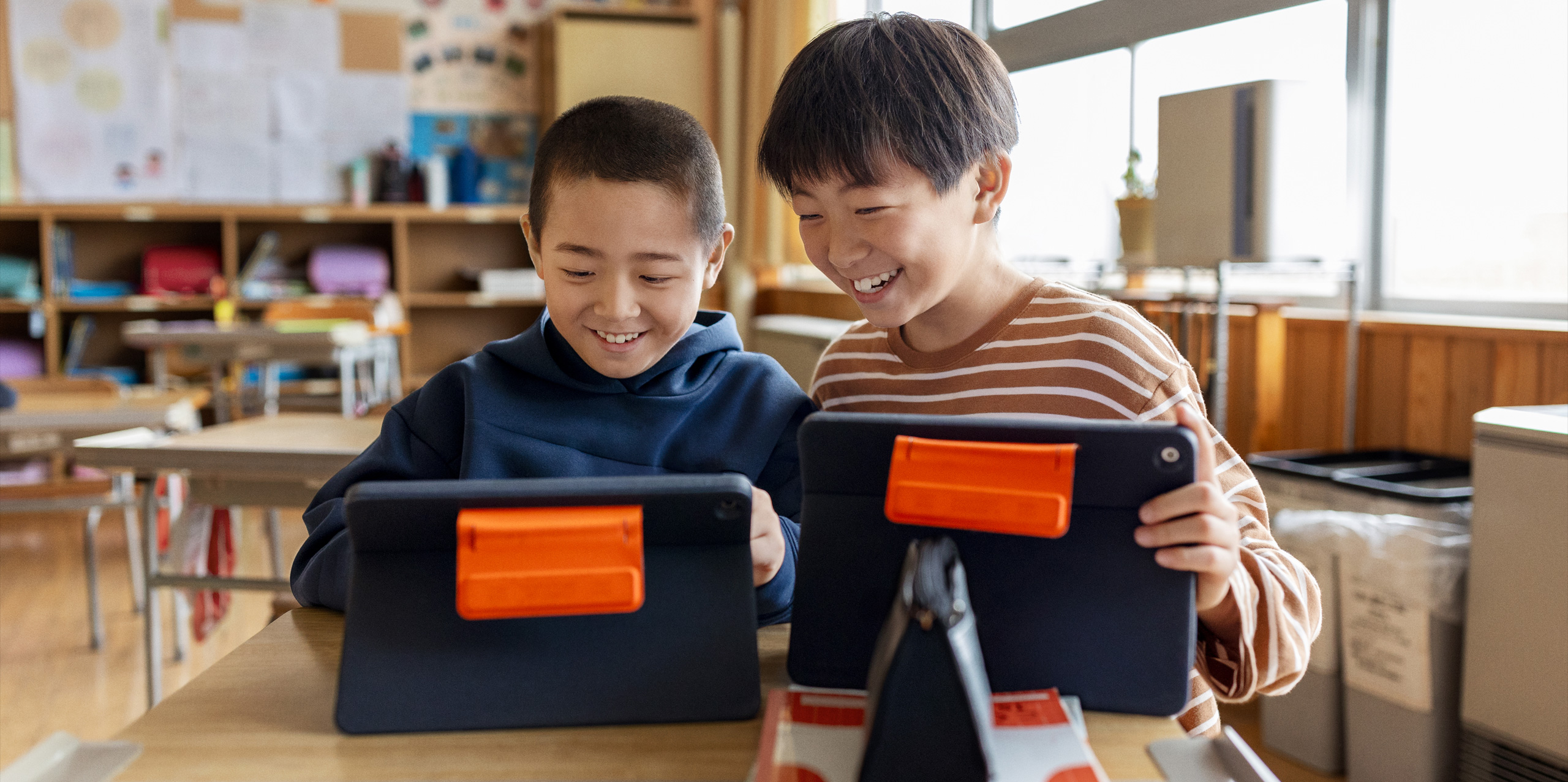 students holding ipads