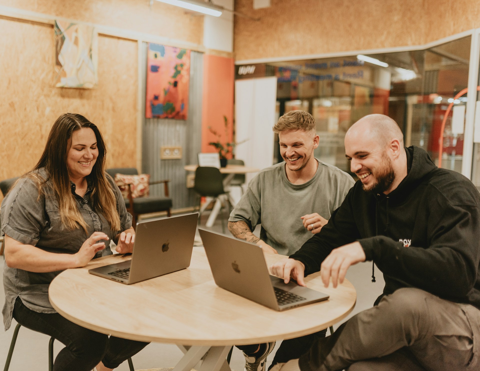 3 person using mac in working place