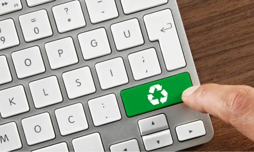 A finger pressing a recycle button on keyboard