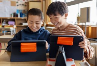 students holding ipads